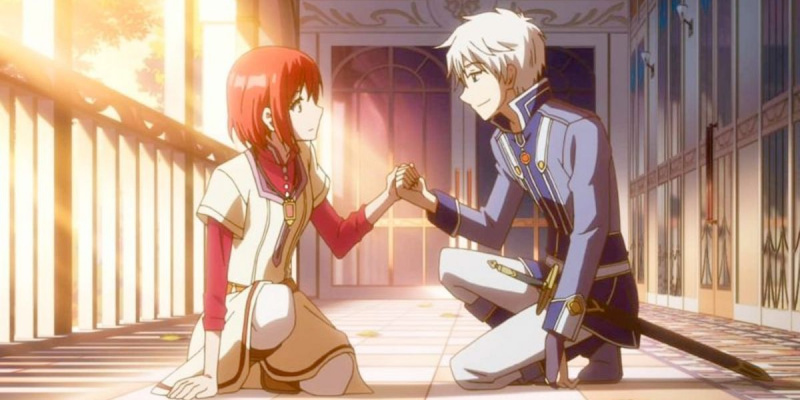   Billedet viser et billede fra Snehvide og det røde hår: (Fra venstre mod højre) Shirayuki (kort, rødt hår og cremefarvet kjole) og Zen (kort, hvid-sølv hår og blå og hvid uniform) holder hinanden i hånden.